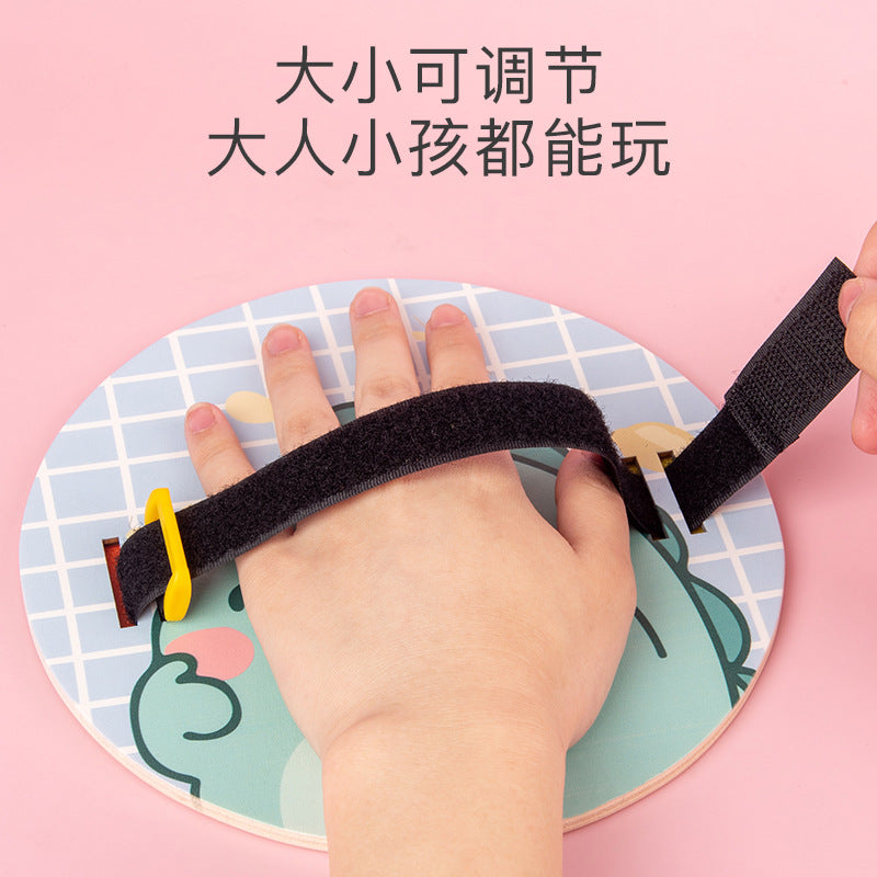 Adjustable hand strap on the wooden toss and catch paddle