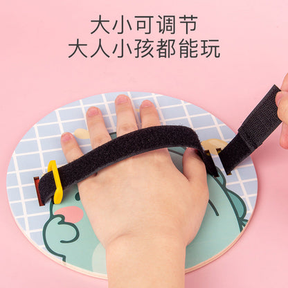 Adjustable hand strap on the wooden toss and catch paddle