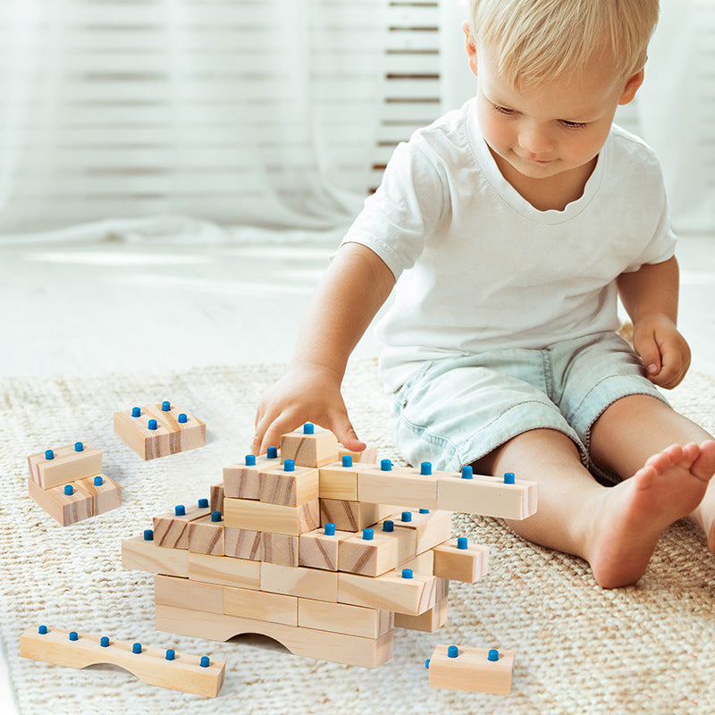 Child playing with wooden Little Architect construction blocks