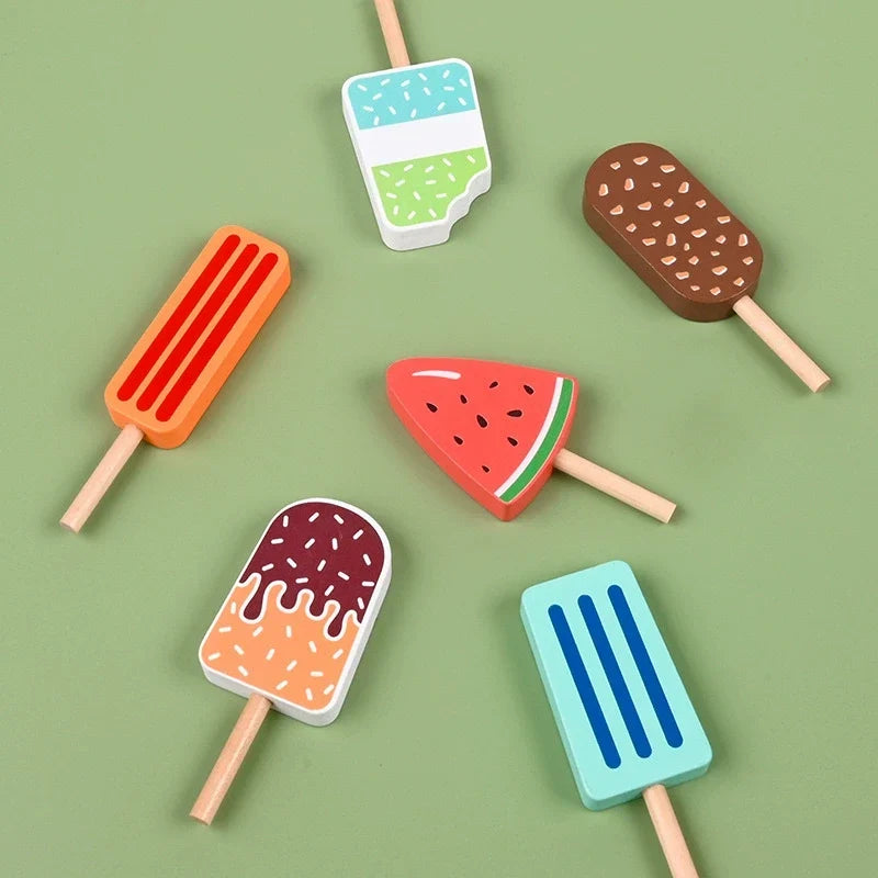 Colorful wooden pretend ice lollies arranged on a green background